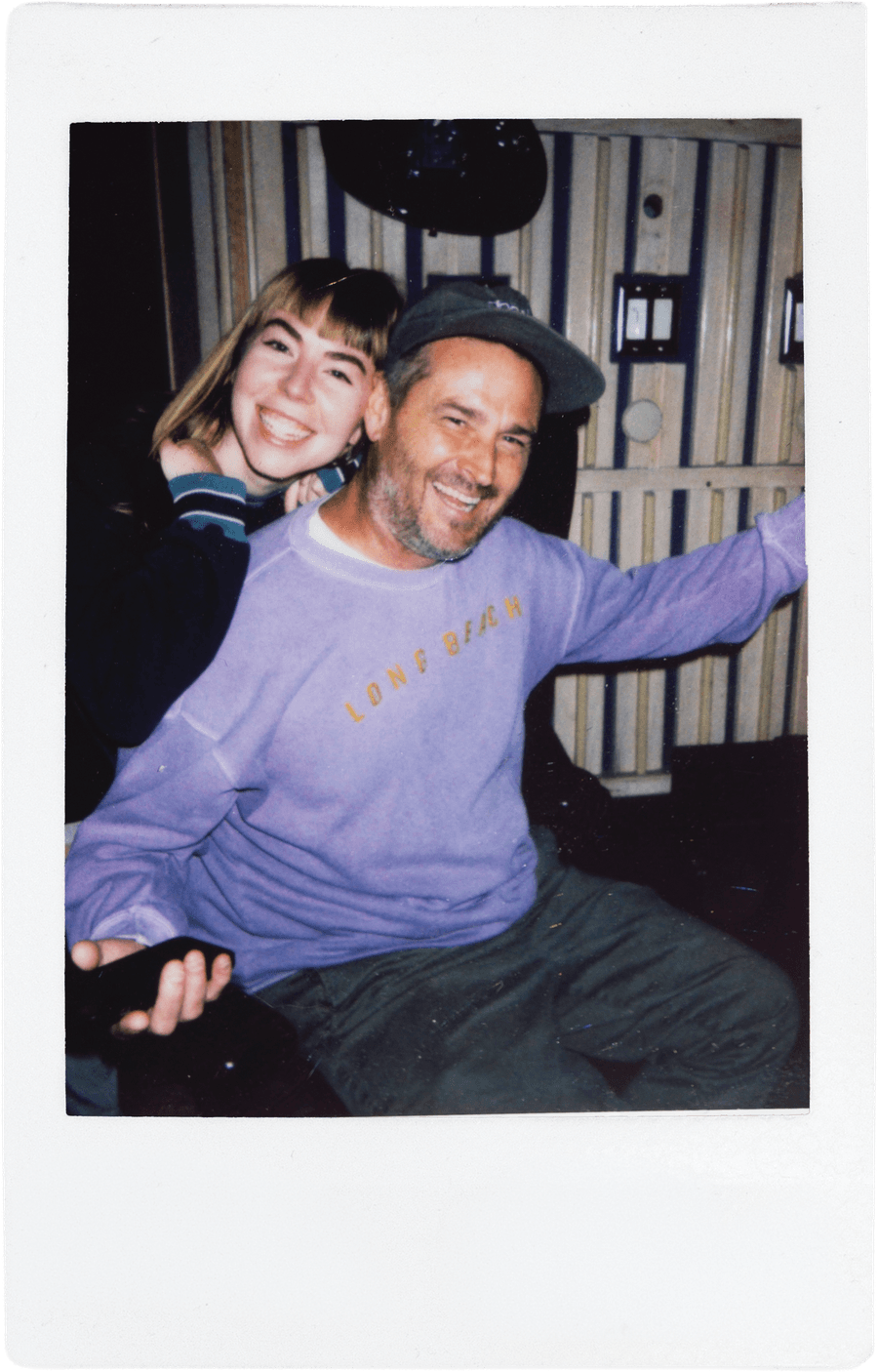 Two team members, one in a purple sweatshirt